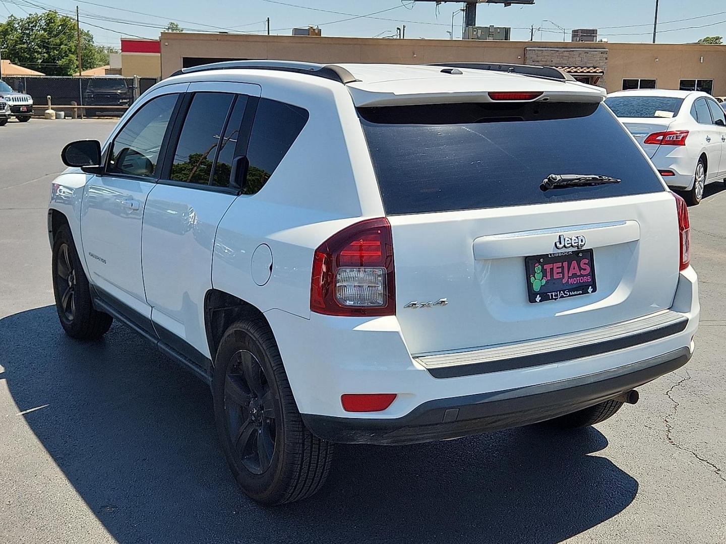 2017 WHITE Jeep Compass Sport 4x4 (1C4NJDBBXHD) with an 2.4L I-4 DOHC, variable valve control, regular unleaded, engine with 172HP engine, located at 4110 Avenue Q, Lubbock, 79412, 33.556553, -101.855820 - Photo#2