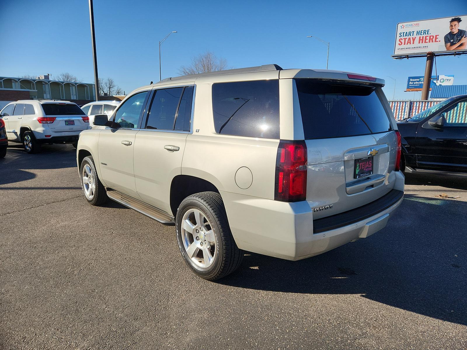 2015 Champagne Silver Metallic /Cocoa/Dune Chevrolet Tahoe LT (1GNSCBKC5FR) with an ENGINE, 5.3L ECOTEC3 V8 WITH ACTIVE FUEL MANAGEMENT, DIRECT INJECTION AND VARIABLE VALVE TIMING engine, located at 4110 Avenue Q, Lubbock, 79412, 33.556553, -101.855820 - Photo #2