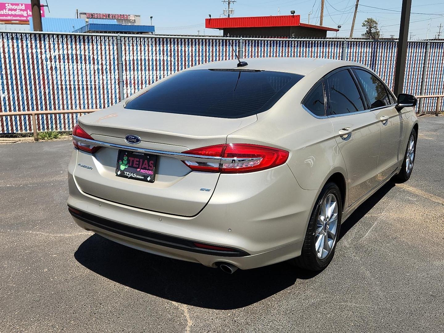 2017 GOLD Ford Fusion SE (3FA6P0H71HR) with an Duratec 2.5L I-4 DOHC, Ti-VCT variable valve control, regular unleaded, engine with 175HP engine, located at 4110 Avenue Q, Lubbock, 79412, 33.556553, -101.855820 - 08/08/2025 KEY IN ENVELOPE GOD - Photo#1