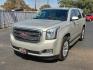2015 GOLD GMC Yukon SLT (1GKS1BKC8FR) with an EcoTec3 5.3L V-8 gasoline direct injection, variable valve control, regular unleaded, engine with cylinder deactivation and 355HP engine, located at 4110 Avenue Q, Lubbock, 79412, 33.556553, -101.855820 - Photo#1