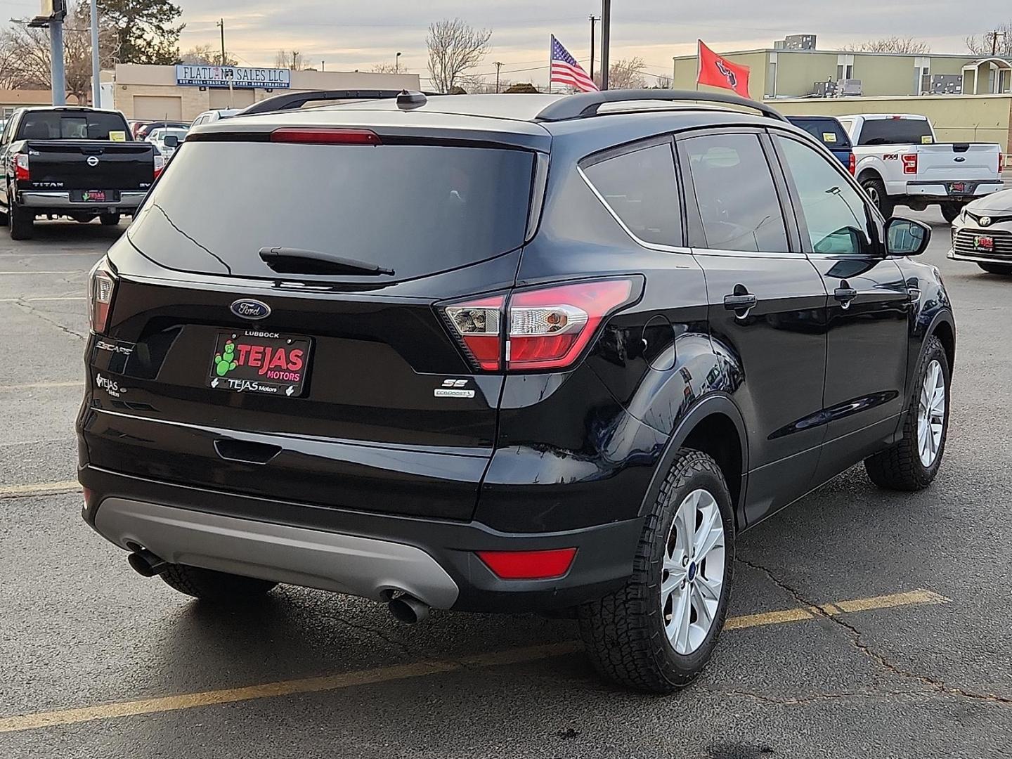 2018 BLACK Ford Escape SE (1FMCU0GD5JU) with an EcoBoost 1.5L I-4 gasoline direct injection, DOHC, variable valve control, intercooled turbo, regular unleaded, engine with 179HP engine, located at 4110 Avenue Q, Lubbock, 79412, 33.556553, -101.855820 - 01/15/2026 KEY IN ENVELOPE GOD - Photo#1