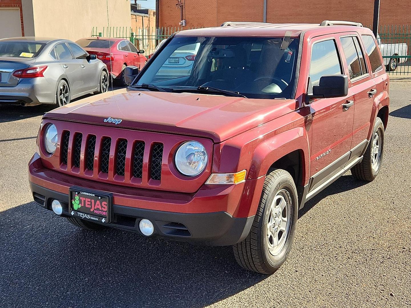 2016 RED Jeep Patriot Sport (1C4NJRBB0GD) with an 2.4L I-4 DOHC, variable valve control, regular unleaded, engine with 172HP engine, located at 4110 Avenue Q, Lubbock, 79412, 33.556553, -101.855820 - 02/11/2026 KEY IN ENVELOPE GOD - Photo#1