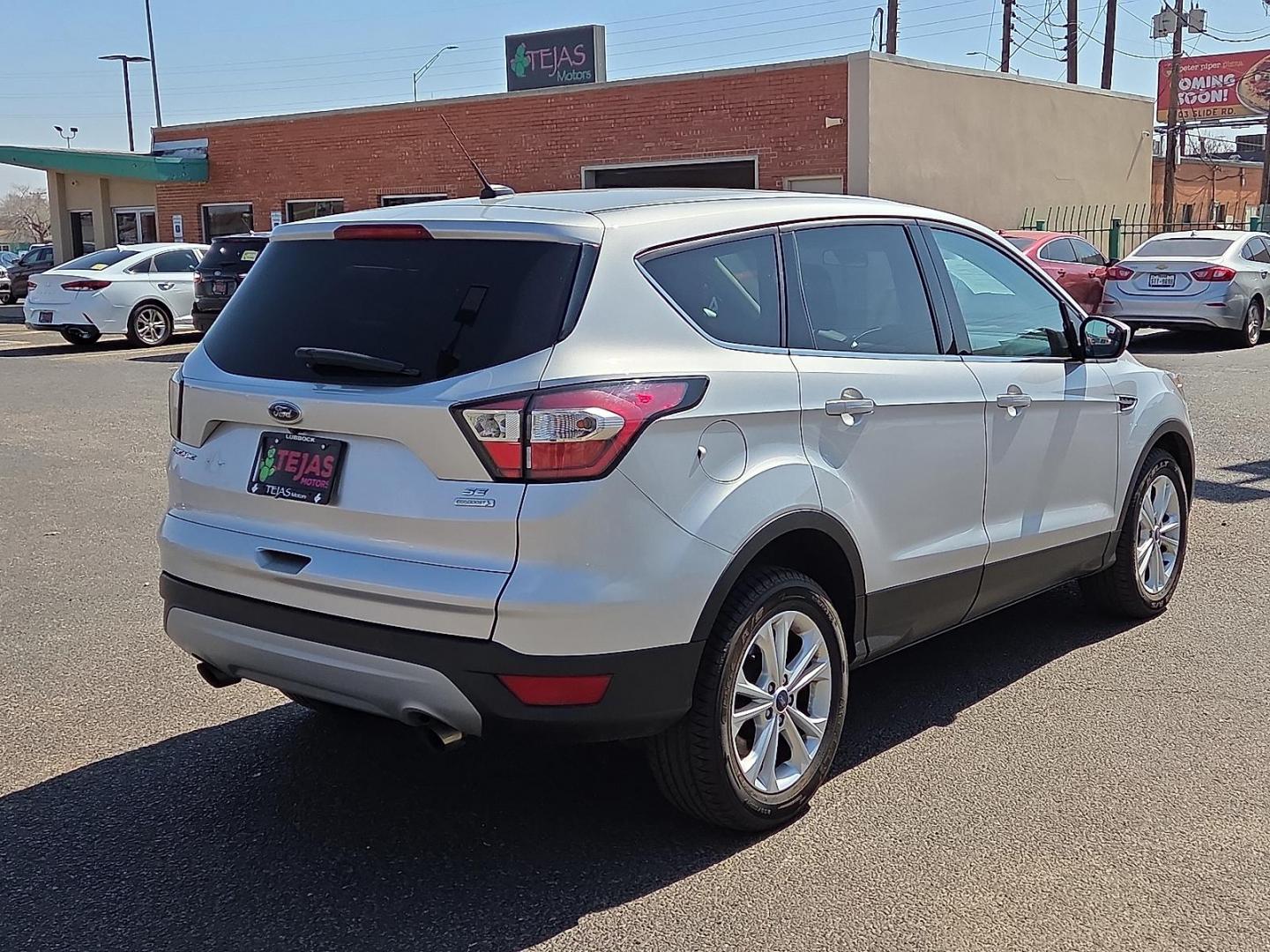 2017 Ingot Silver Metallic - UX /Charcoal Black - KB Ford Escape SE (1FMCU0GDXHU) with an EcoBoost 1.5L I-4 gasoline direct injection, DOHC, variable valve control, intercooled turbo, regular unleaded, engine with 179HP engine, located at 4110 Avenue Q, Lubbock, 79412, 33.556553, -101.855820 - Photo#2